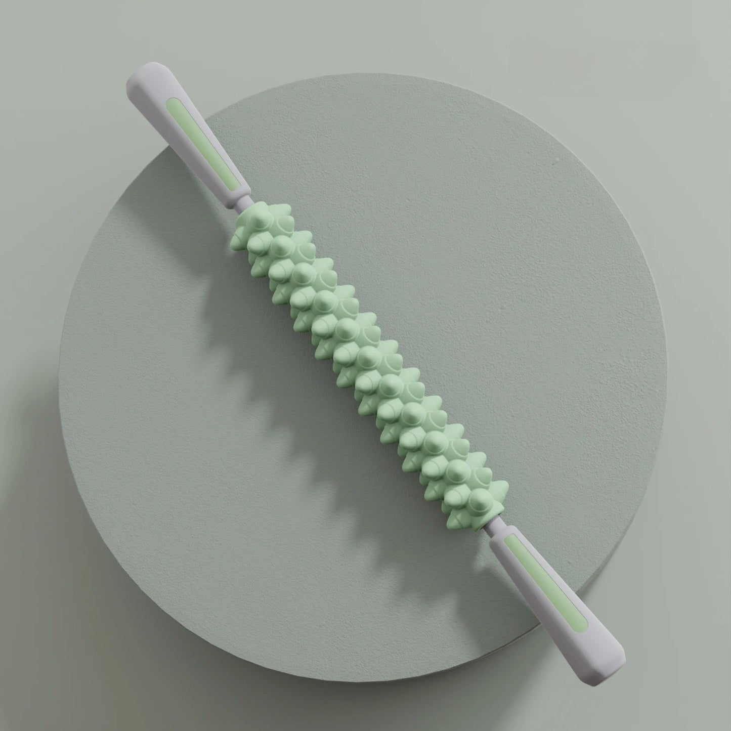 Rouleau de massage vert à poignées, socle gris circulaire