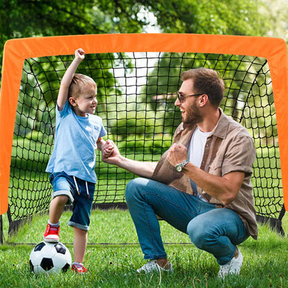pere et fils contant davant une cage de foot