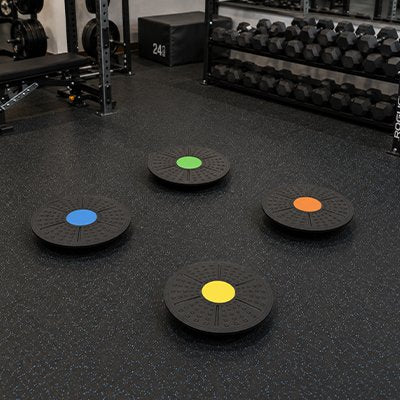 Quatre Planche d'équilibre posées au sol dans une salle.